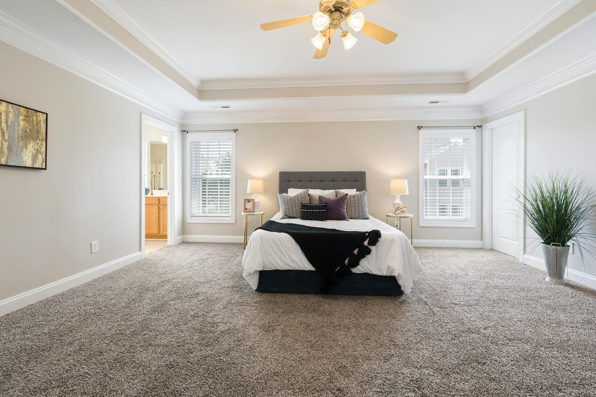 Bright and spacious bedroom with modern decor featuring a plush bed and soft lighting.
